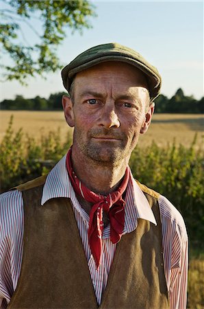 schiebermütze - A man with a red neckerchief and flat hat, in working shirt and waistcoat. Stockbilder - Premium RF Lizenzfrei, Bildnummer: 6118-07781854