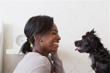 simsearch:6118-07731792,k - A young girl playing with her small black pet dog. Stock Photo - Premium Royalty-Free, Code: 6118-07731743