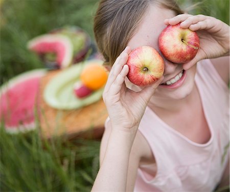 simsearch:6118-07731949,k - A girl holding two apples in front of her eyes Photographie de stock - Premium Libres de Droits, Code: 6118-07731964