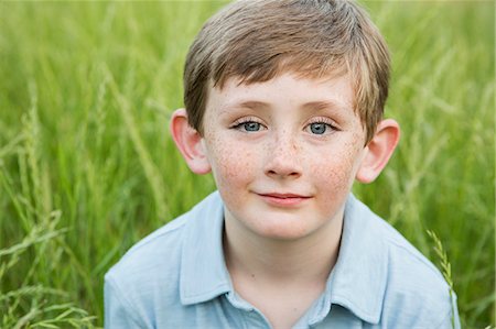 serious kids outside - A boy in a blue shirt with brown hair and freckles. Stock Photo - Premium Royalty-Free, Code: 6118-07731972