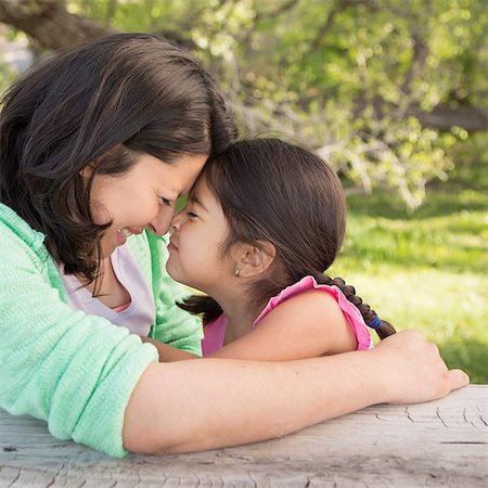 simsearch:6118-07731806,k - A mother in the park with her daughter, laughing and kissing each other. Photographie de stock - Premium Libres de Droits, Code: 6118-07732064