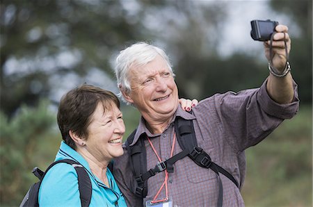 A mature couple taking a selfy photograph while out walking. Stock Photo - Premium Royalty-Free, Code: 6118-07808945