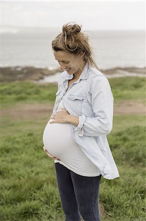 fertility - A pregnant woman on a coastal path. Stock Photo - Premium Royalty-Free, Code: 6118-07808951