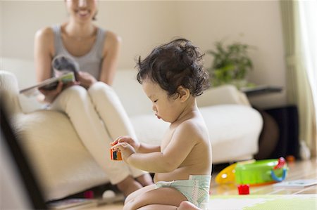 sitting baby diaper - Baby boy playing indoors. Stock Photo - Premium Royalty-Free, Code: 6118-07809005