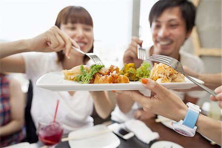 simsearch:6118-07813281,k - Group of friends sharing a meal. Stock Photo - Premium Royalty-Free, Code: 6118-07813269