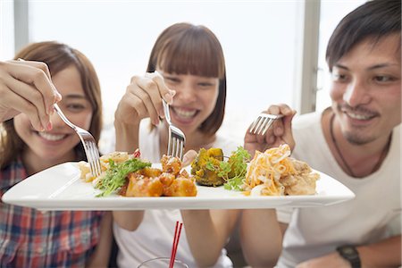 simsearch:6118-07813281,k - Group of friends sharing a meal. Stock Photo - Premium Royalty-Free, Code: 6118-07813270