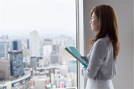 A working woman in an office building. Stock Photo - Premium Royalty-Free, Code: 6118-07813219