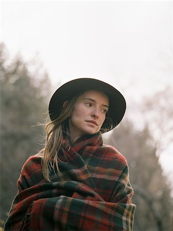 emballé - Young blond woman wearing a hat, wrapped in a blanket. Photographie de stock - Premium Libres de Droits, Code: 6118-07944773