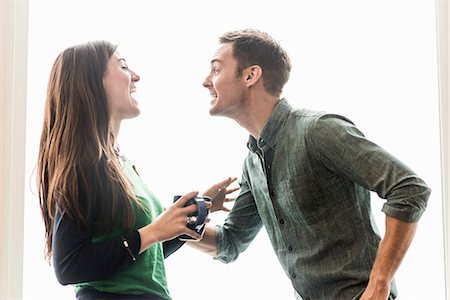 A man and woman talking in an office over coffee. Stock Photo - Premium Royalty-Free, Code: 6118-08066720