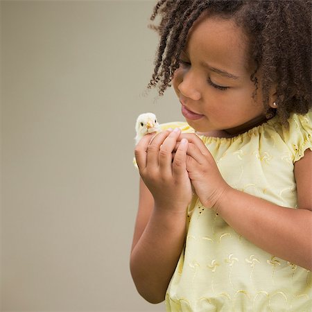A girl holding a baby chick. Stock Photo - Premium Royalty-Free, Code: 6118-08081862