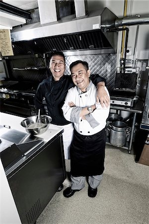 Two cooks in a commercial restaurant kitchen. Photographie de stock - Premium Libres de Droits, Code: 6118-08081883