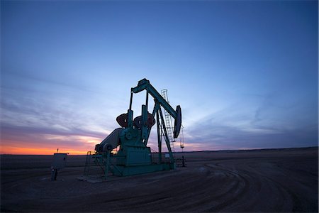 simsearch:6118-08088552,k - A pumpjack at an oil drilling site at sunset. Stockbilder - Premium RF Lizenzfrei, Bildnummer: 6118-08088550