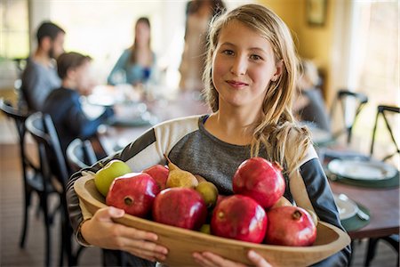 simsearch:6118-08001552,k - A girl carrying a basket of apples. Stock Photo - Premium Royalty-Free, Code: 6118-08001563