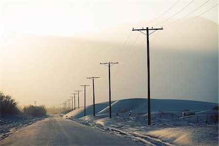 pole - Power lines reaching into the distance, with a mountain backdrop. Stock Photo - Premium Royalty-Free, Code: 6118-08023777