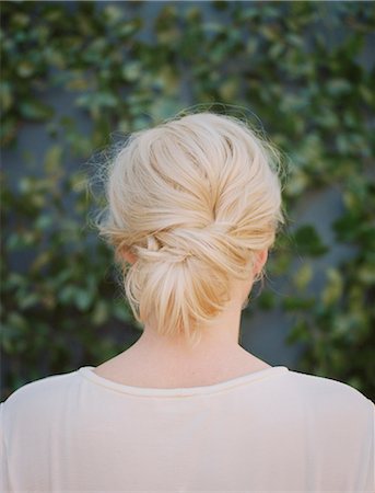 A woman with blonde hair arranged in a knot at the nape of her neck. Stockbilder - Premium RF Lizenzfrei, Bildnummer: 6118-08023781