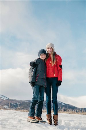 simsearch:6118-08023790,k - A brother and sister standing side by side in the snow. Stock Photo - Premium Royalty-Free, Code: 6118-08023791