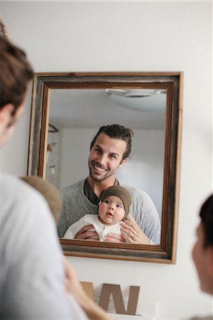 full body mirror reflection - A mother and father with their baby, looking in the mirror. Stock Photo - Premium Royalty-Free, Code: 6118-08023720