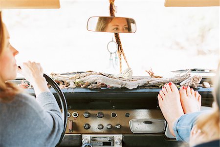 simsearch:6118-08140189,k - A woman resting her bare feet on the dashboard of a 4x4, on a road trip with another woman driving. Stock Photo - Premium Royalty-Free, Code: 6118-08140172