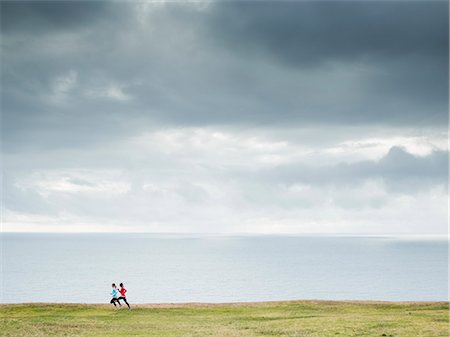 simsearch:6118-08129648,k - Two women jogging along the coast. Stock Photo - Premium Royalty-Free, Code: 6118-08129650