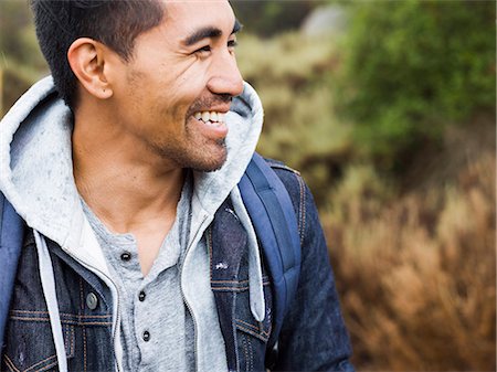 simsearch:6118-08129648,k - A young man smiling. Photographie de stock - Premium Libres de Droits, Code: 6118-08129658