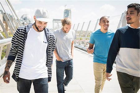 free time - Group of young men walking along a bridge. Stock Photo - Premium Royalty-Free, Code: 6118-08129676