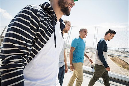 simsearch:6118-08129675,k - Group of young men walking along a bridge. Stockbilder - Premium RF Lizenzfrei, Bildnummer: 6118-08129679