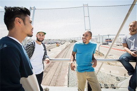 simsearch:6118-08129691,k - Group of young men standing on a bridge. Foto de stock - Sin royalties Premium, Código: 6118-08129680