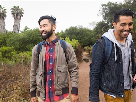 simsearch:6118-08129648,k - Two smiling young men walking in a park. Stock Photo - Premium Royalty-Free, Code: 6118-08129619