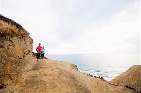 simsearch:6118-08129648,k - Two women jogging along the coast. Stock Photo - Premium Royalty-Free, Code: 6118-08129718