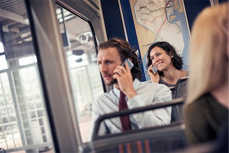 Two people seated on a bus talking on their cell phones Photographie de stock - Premium Libres de Droits, Code: 6118-08243853
