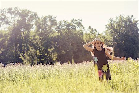 simsearch:6118-07351879,k - A child, a young girl in straw hat in a meadow of wild flowers in summer. Stock Photo - Premium Royalty-Free, Code: 6118-08243894