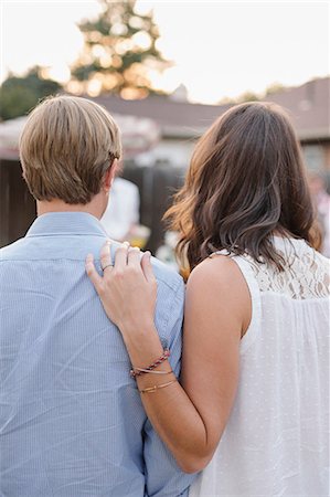 simsearch:6118-08282226,k - Rear view of a couple standing side by side in a garden, woman touching man's shoulder. Photographie de stock - Premium Libres de Droits, Code: 6118-08282232