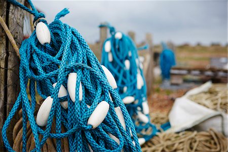 Close up of a tangle of blue fisherman's rope with white floats. Stock Photo - Premium Royalty-Free, Code: 6118-08202546