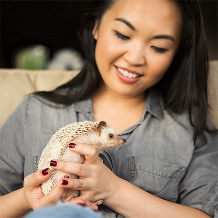 simsearch:6118-09018328,k - A woman holding a hedgehog in her hands. Photographie de stock - Premium Libres de Droits, Code: 6118-08202556