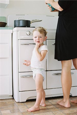 diaper boys - A woman and a child, a young boy standing barefoot in a kitchen. Stock Photo - Premium Royalty-Free, Code: 6118-08202510