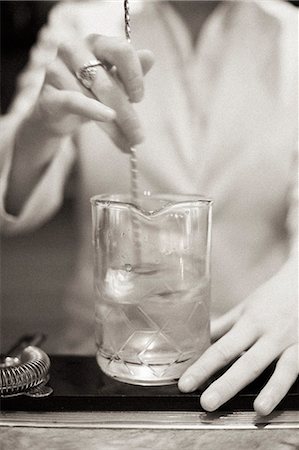 restaurant vintage - A young woman mixing a cocktail, a mixologist at work. Stock Photo - Premium Royalty-Free, Code: 6118-08226899