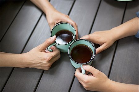 Two people seated at a table, drinking coffee, viewed from above. Stock Photo - Premium Royalty-Free, Code: 6118-08226978