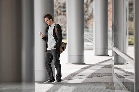 simsearch:6118-08351887,k - A man outside a building, checking his smart phone. Stockbilder - Premium RF Lizenzfrei, Bildnummer: 6118-08351968