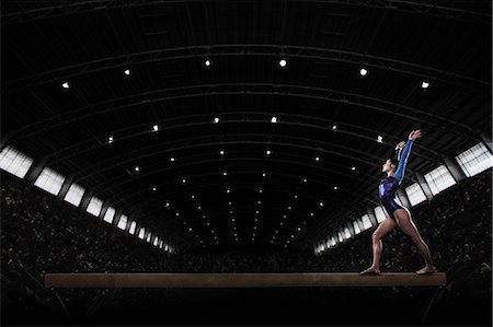 simsearch:6118-08352013,k - A young woman gymnast performing on the beam, balancing on a narrow piece of apparatus. Stock Photo - Premium Royalty-Free, Code: 6118-08352011