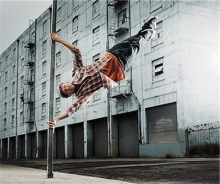 simsearch:6118-08393906,k - A young man breakdancing, leaping in the air, and stretching out. Stock Photo - Premium Royalty-Free, Code: 6118-08393901