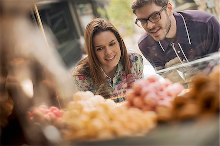 romantic date places - A couple looking at the window display in a confectionery shop. Stock Photo - Premium Royalty-Free, Code: 6118-08394176