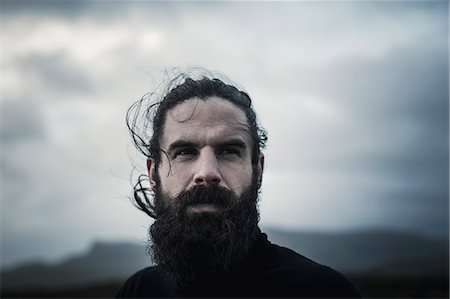 frontal man - A man with black hair, a full beard and moustache. Stock Photo - Premium Royalty-Free, Code: 6118-08399695