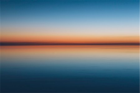 simsearch:6118-08827575,k - The view to the clear line of the horizon where land meets sky, across the flooded surface of Bonneville Salt Flats. Dawn light, Stock Photo - Premium Royalty-Free, Code: 6118-08313772