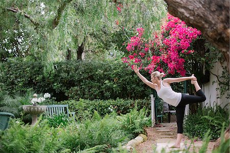 Blond woman doing yoga in a garden. Photographie de stock - Premium Libres de Droits, Code: 6118-08313707