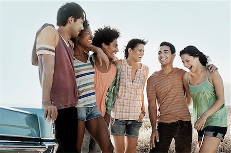 A group of friends, men and women, on the open road, walking and talking. Stock Photo - Premium Royalty-Free, Code: 6118-08488119