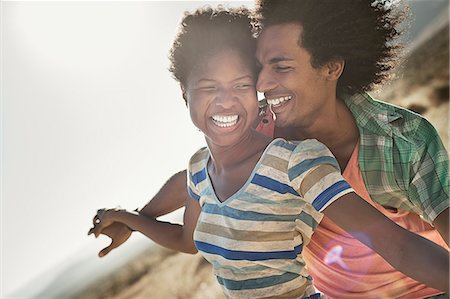 simsearch:6118-08991581,k - A couple with arms outstretched in a gesture of freedom and excitement, leaning into the breeze. Stock Photo - Premium Royalty-Free, Code: 6118-08488128