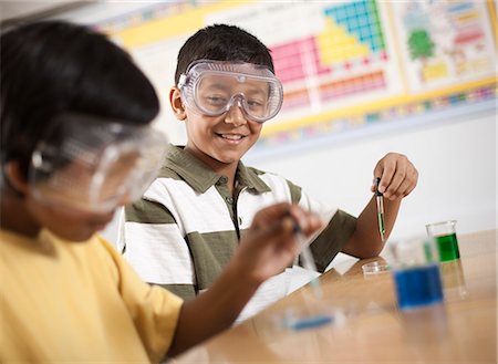 simsearch:614-06403067,k - Two young people, boy and girl in a science lesson, wearing eye protectors and working on an experiment. Stock Photo - Premium Royalty-Free, Code: 6118-08488283