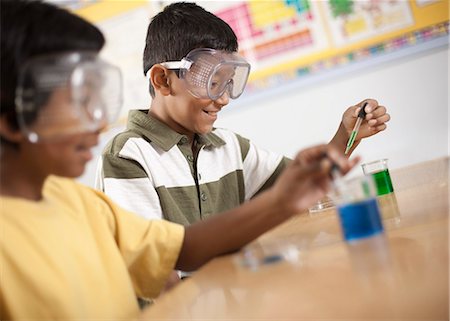 simsearch:614-06403067,k - Two young people, boy and girl in a science lesson, wearing eye protectors and working on an experiment. Stock Photo - Premium Royalty-Free, Code: 6118-08488282