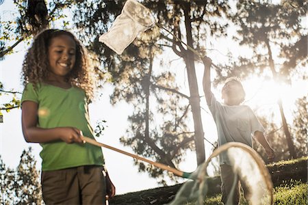 simsearch:6118-07732026,k - Two children using butterfly nets to try and catch butterflies. Stock Photo - Premium Royalty-Free, Code: 6118-08488340