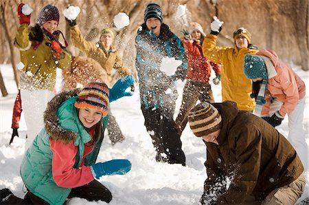A group of young people, boys and girls having a snowball fight. Stock Photo - Premium Royalty-Free, Code: 6118-08488400